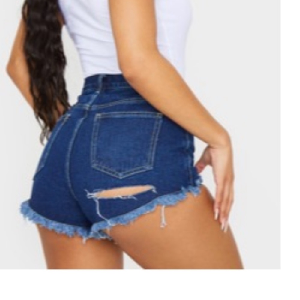 pretty little thing dark wash jean shorts with slit on the back